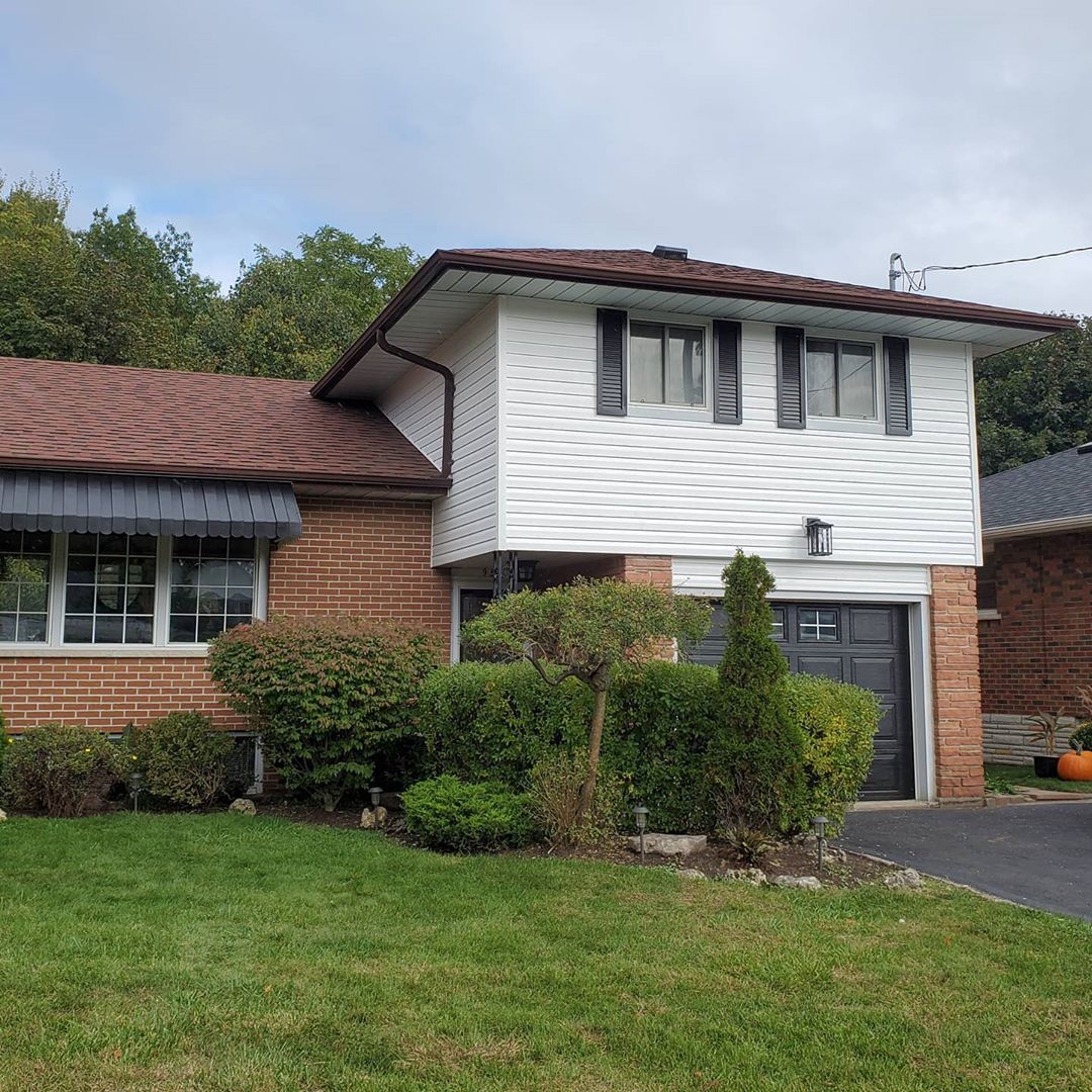 white vinyl siding with black shutters