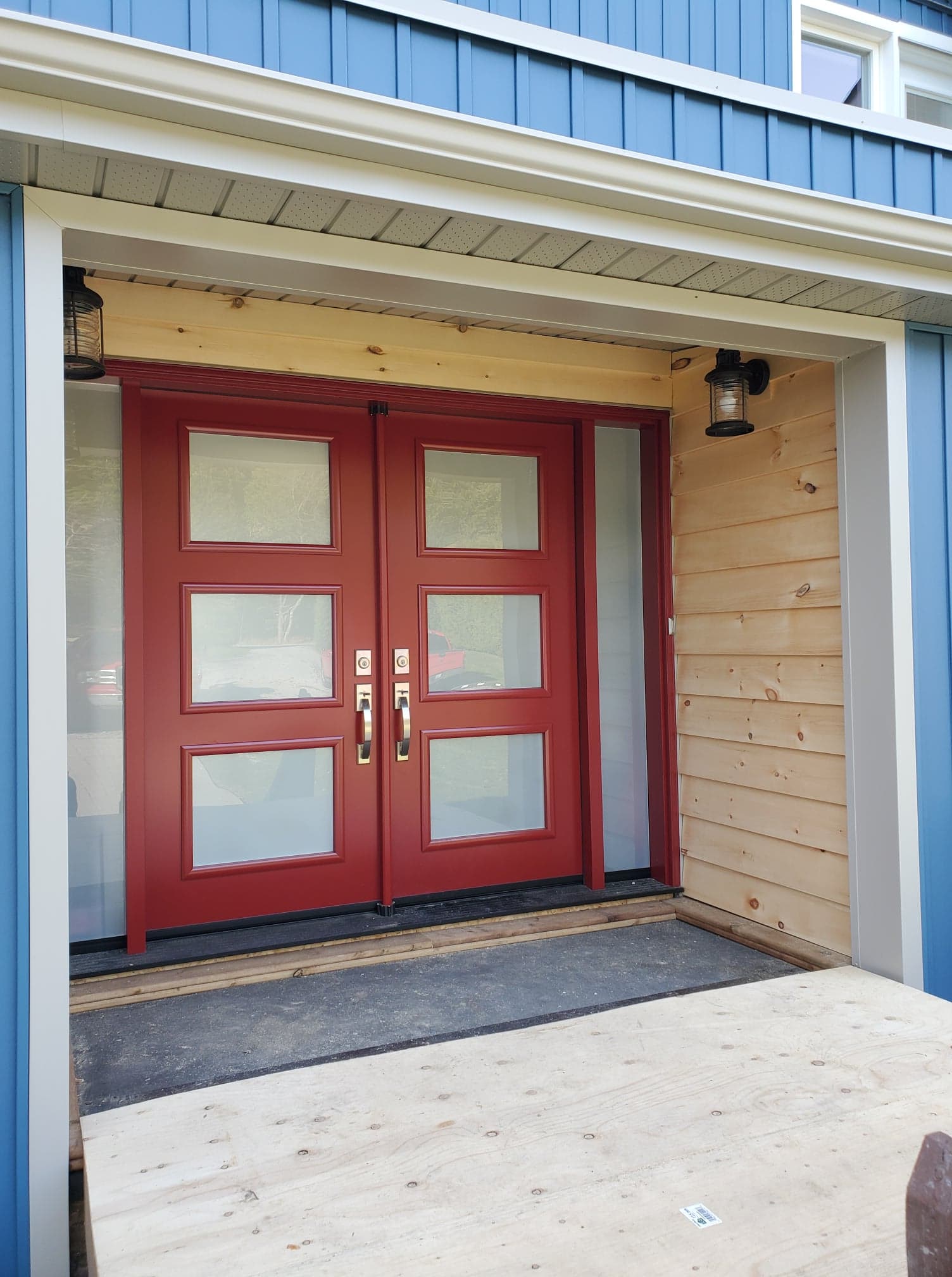 knotty pine accent wall with heritage blue board and batten siding